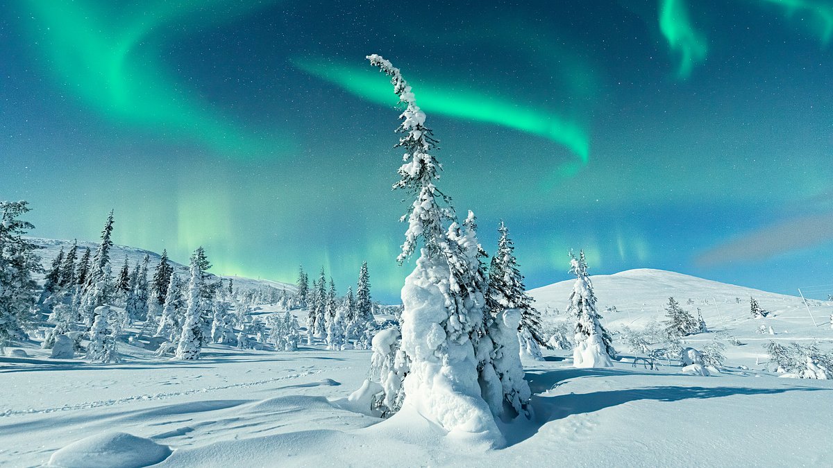 Northern Lights over a snow-covered Icelandic landscape